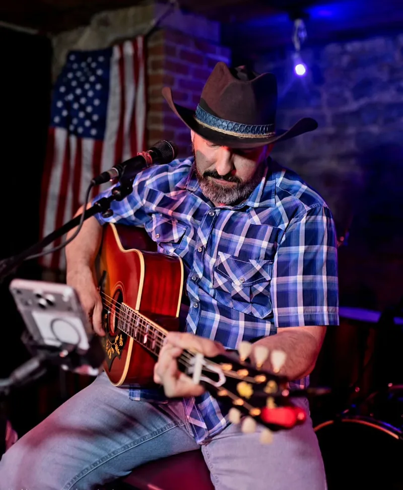 Matt Welch performing with an acoustic guitar